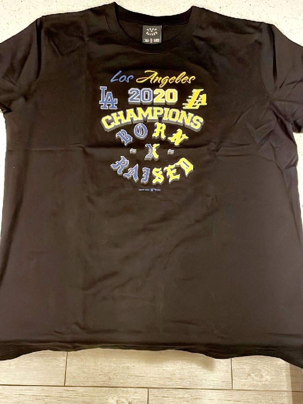 BORN X RAISED Black Tee with Blue & Yellow Los Angeles Champions Graphic